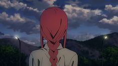 a woman with long red hair standing in the middle of a street at night, looking off into the distance