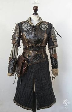 a mannequin dressed in armor and holding a bag