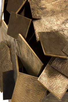 a large pile of gold colored metal pieces
