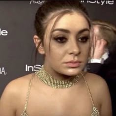 a woman wearing a gold necklace and choker at an instyle event in new york city