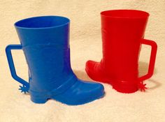 two red and blue rain boots sitting next to each other on a white carpeted floor