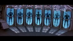 the reflection of two men in mirrors on a building's roof is seen from below