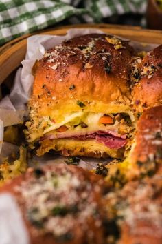 a sandwich cut in half sitting on top of a basket next to other food items
