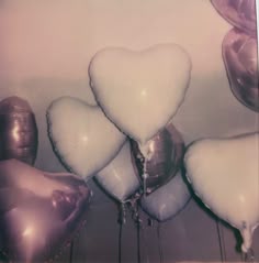 there are many balloons in the shape of hearts