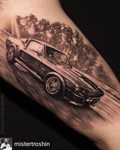 a black and white photo of a muscle car on the arm