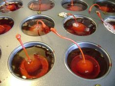 cupcake tins filled with cherries and syrup