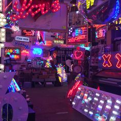 a room filled with lots of neon signs and lights