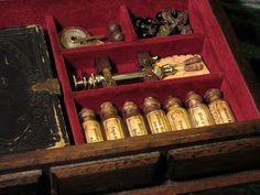 an open wooden box with many items in it