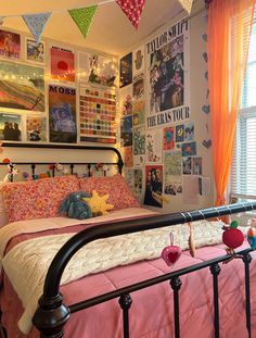a bed room with a neatly made bed and lots of pictures on the wall