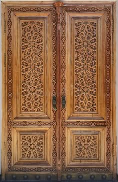 an ornate wooden door with intricate carvings on the front and side panels, made from wood