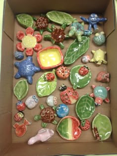 a box filled with ceramic figurines sitting on top of a table