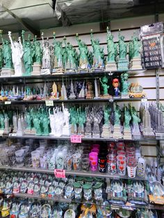 the shelves are filled with souvenirs and figurines in different shapes and sizes