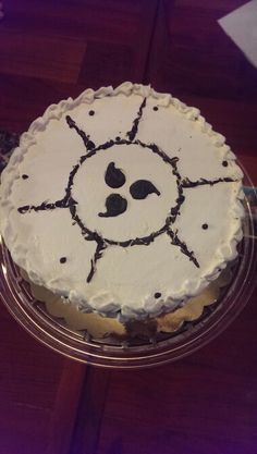 a cake with white frosting and black decorations