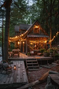 a small cabin in the woods with lights strung from it's roof and porch