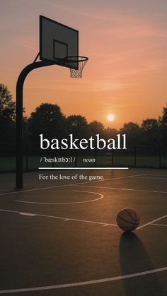 a basketball ball sitting on top of a basketball court with the sun setting in the background