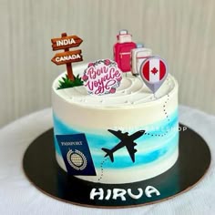there is a cake that has been decorated with travel signs and luggage on the top