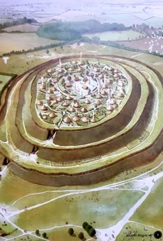 an aerial view of a circular structure in the middle of a field
