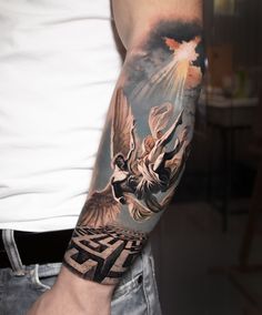 a man's arm with an angel tattoo on it