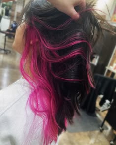 Pink peekaboo highlights underneath  of natural dark brown brunette hair