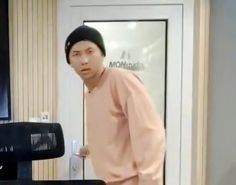 a man standing in front of a computer monitor