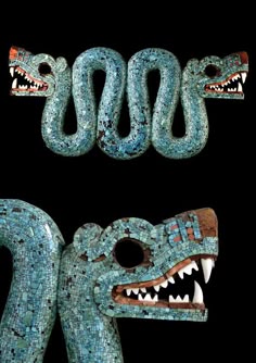 two pieces of art made out of blue and green glass beads with teeth on them