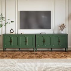 a living room with a large tv mounted on the wall and green cabinet doors in front of it