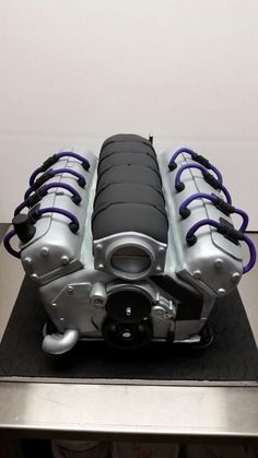 a motorcycle engine cake sitting on top of a table