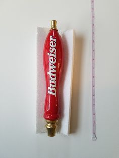 a red pepper bottle sitting on top of a white piece of paper