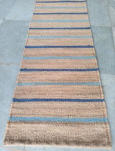 a blue and beige striped rug on the floor
