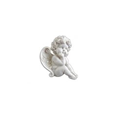 a small white angel figurine sitting on the ground