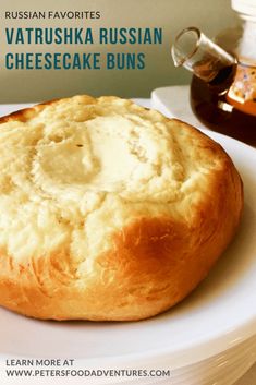 a close up of a bread on a plate with honey in the background and text overlay that reads russian favorites vatrushka russian cheesecake buns