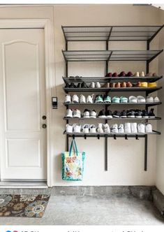 there are many pairs of shoes on the shelves in this room and one bag is hanging from the wall