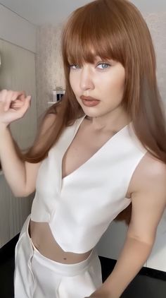 a woman with red hair is posing for the camera