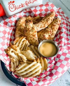 chicken wings with fries and ketchup on a red and white checkered plate