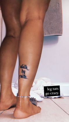a woman's legs with the words walk by faith written on her left leg