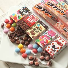 several different types of candy on a white tray