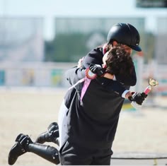 a man and woman hug each other on the beach