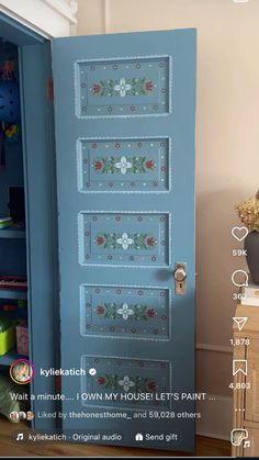 a blue door with flowers painted on it