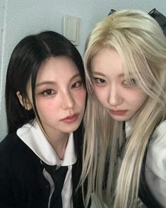 two young women are posing for the camera