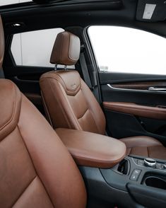 the interior of a car with brown leather seats