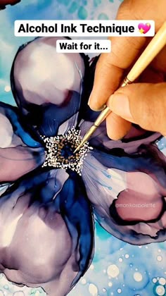 someone is painting a flower with watercolors on it and the words alcohol ink technique wait for it
