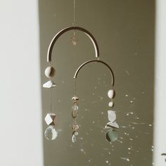 a wind chime hanging from the side of a wall