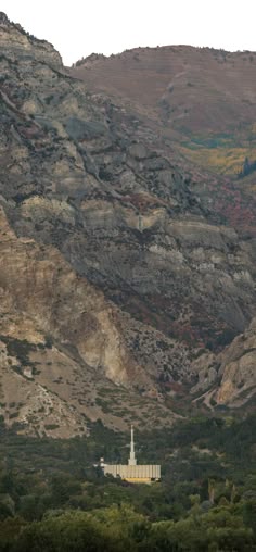 a mountain side with a church in the foreground