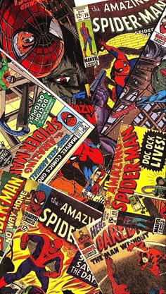 many different comics are stacked on top of each other in this pile, with one being the spider - man