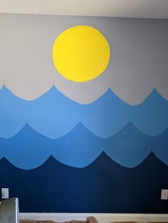 a bedroom with blue and yellow waves painted on the wall