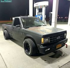 a truck parked in front of a gas station