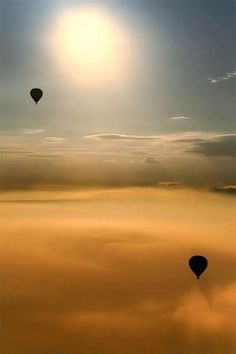 three hot air balloons flying in the sky