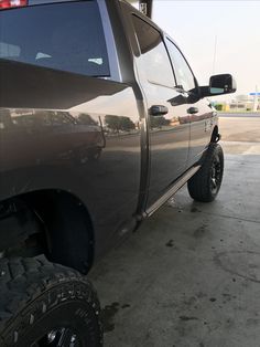 the truck is parked on the side of the road with it's flat tire