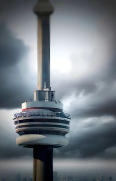 a tall tower with a sky background and dark clouds in the foreground, as seen from an observation platform