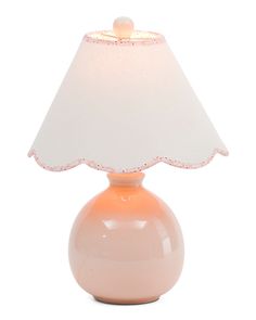 an orange lamp with a white shade on it